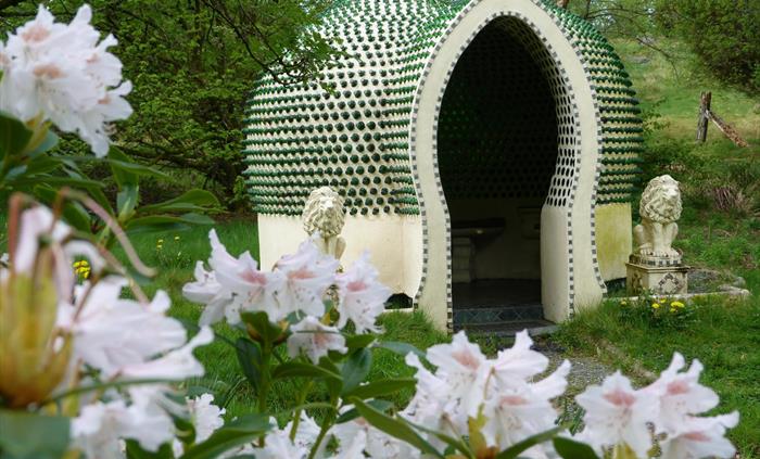 A temple, constructed out of over 2,500 dumpy bottles, creating beautiful light and acoustics. It is flanked by concrete lions, and a rhododendron in
